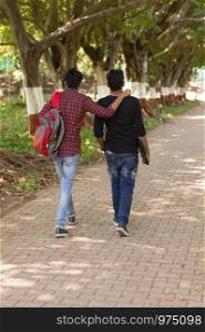 Two young students going to college and on shoulder