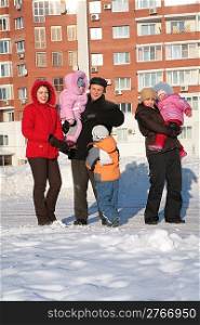 two young woman and grandfather with children .winter.