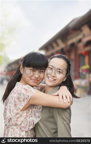 two young woman embracing