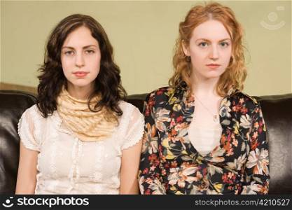 Two Young Woman Looking Blase and Apprehensive