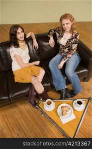 Two Young Woman Sitting over Coffee