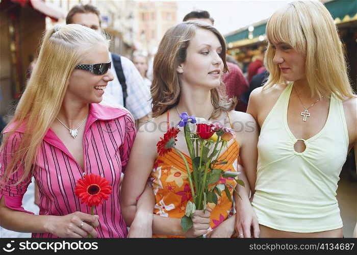 Two young women and a teenage girl smiling