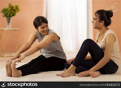 Two young women exercising in living room