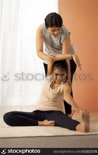 Two young women exercising in living room