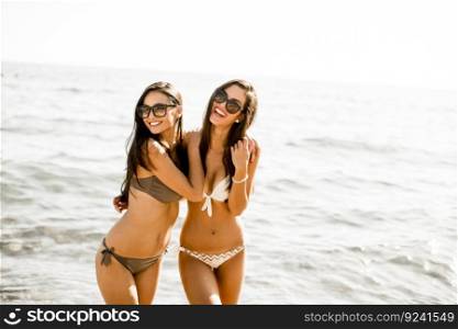 Two young women in bikini on the beach