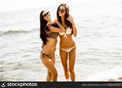 Two young women in bikini on the beach