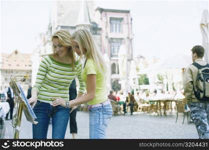 Two young women looking at a menu