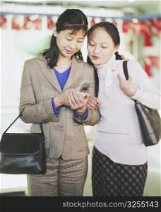Two young women looking at a mobile phone