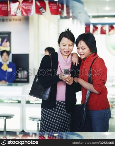 Two young women looking at a mobile phone