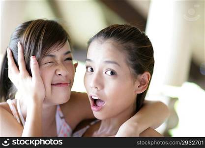 Two young women making faces
