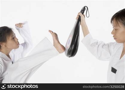 Two young women practicing karate