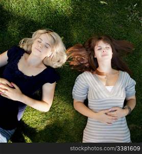 Two young women relaxing on grass