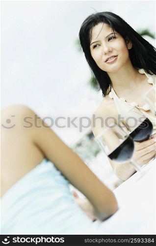 Two young women sitting at the table with glasses of wine in front of them