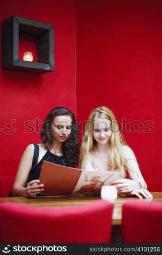Two young women sitting in a restaurant