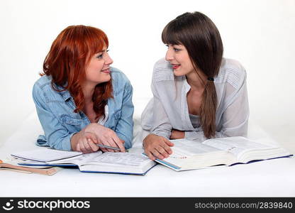 Two young women studying