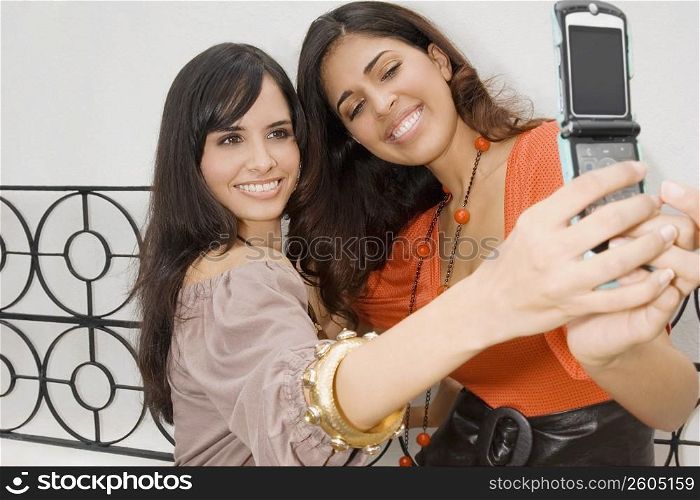 Two young women taking a photograph of themselves