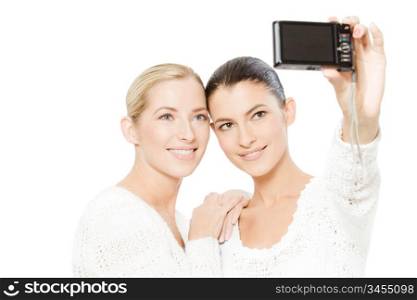 two young women taking pictures of themselves, isolated on white