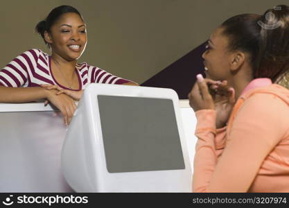 Two young women talking to each other