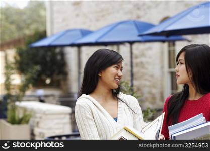 Two young women talking to each other