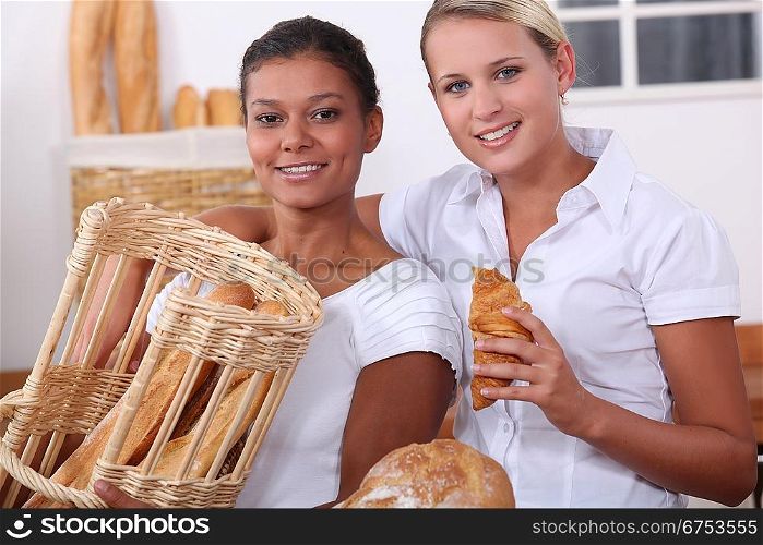 Two young women working in a bakery