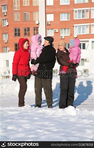 two yuong woman and grandfather with children on the walk in the winter 2