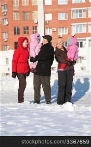 two yuong woman and grandfather with children on the walk in the winter 2