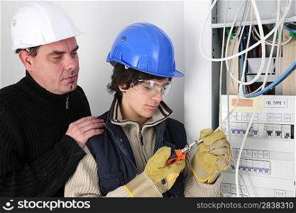 twosome of electricians: trainer and apprentice