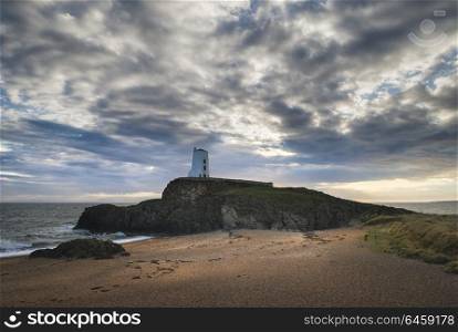 Twr Mawr lighthouse landscape from beach with dramatic sky and cloud formations