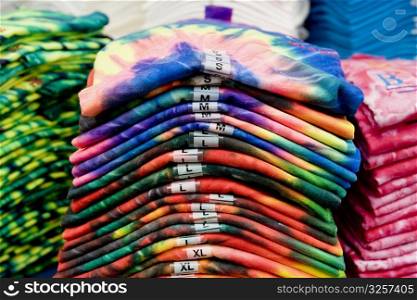 Tye-dye t-shirts folded into a pile