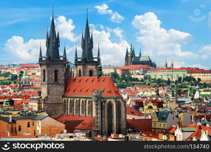 Tynsky and St Vita cathedrals among the red roofs of Prague. View from above