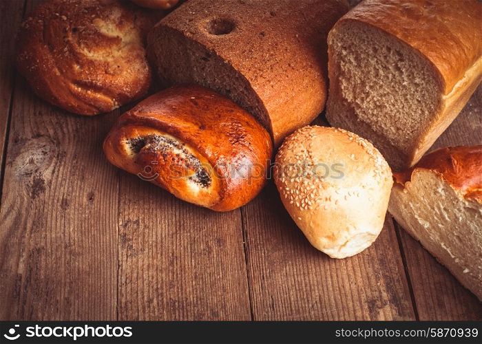 Types of homemade bread on the rustic wooden table. Types of bread