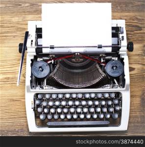 Typewriter and a blank sheet of paper