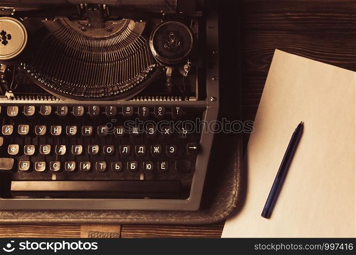 typewriter and a white sheet and ballpoint pen. typewriter and a white sheet and ballpoint pen. Retro style