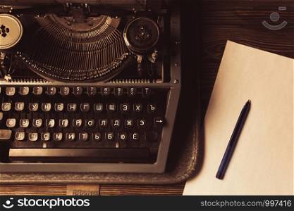 typewriter and a white sheet and ballpoint pen. typewriter and a white sheet and ballpoint pen. Retro style