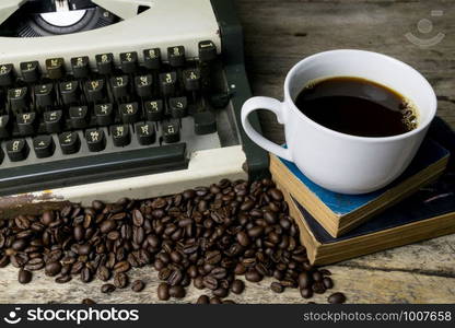 typewriter and coffee on wood background