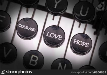 Typewriter with special buttons, courage love hope