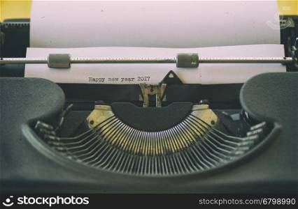 Typewriter with text written Happy New Year 2017