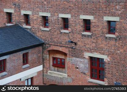 typical british architecture of a antique warehouse building (brick wall)