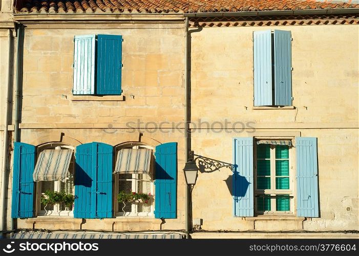 Typical building wall and windows at sunset in Arles, France