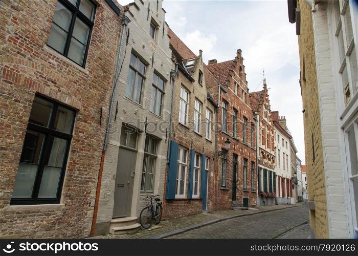Typical, charming street with bicycle by door. Bruges, West Flanders, Belgium, Europe.