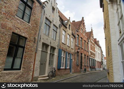 Typical, charming street with bicycle by door. Bruges, West Flanders, Belgium, Europe.