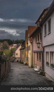 Typical German small town street and buildings. Street alley with typical colorful German houses and buildings, in the evening, in the small town of Schwabisch Hall, Germany.