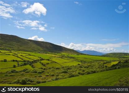 Typical green Irish country side with blue sky and cluds