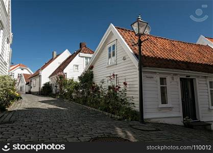 Typical houses and cobblestone street in Stavanger, Norway. Typical houses in Stavanger, Norway