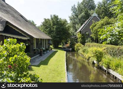 typical houses with garden in the dutch place Giethoorn, called the venice of the north