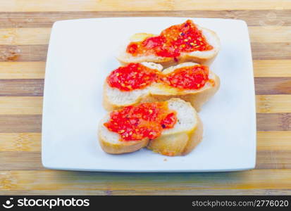 "Typical italian appetizer "bruschette" with tomato over white plate"