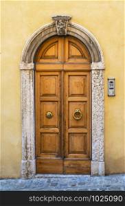 Typical italian facade with door. Italian house. Traditional style and ornaments.