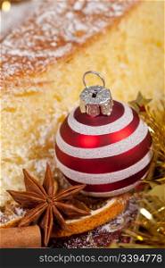 Typical italian Pandoro cake and red decoration ball for Christmas