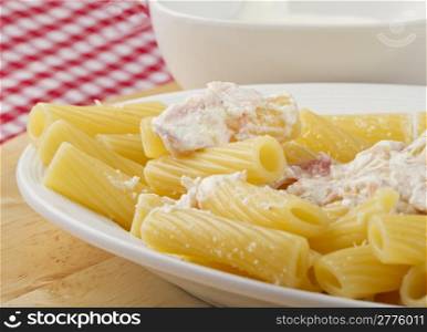 Typical Italian pasta maccheroni with ham and cream