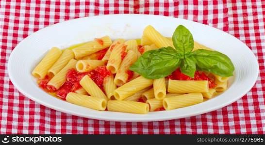 Typical Italian pasta maccheroni with raw tomatoes